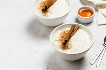 Condensed milk  rice pudding in bowls. Space for text.