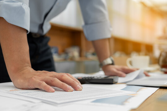 Close up of male hand on table. Businessman standing near table, leaning his hands on table.