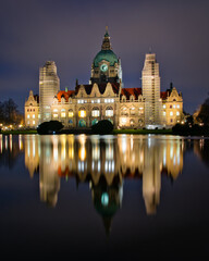 Fototapeta na wymiar New Town Hall (Neues Rathaus) with a reflection of the building in the lake taken at night with a long exposure, Hanover, Lower Saxony, Germany 