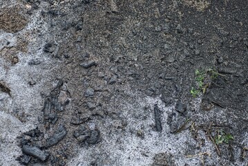 gray white texture of soot and ash on white snow outside