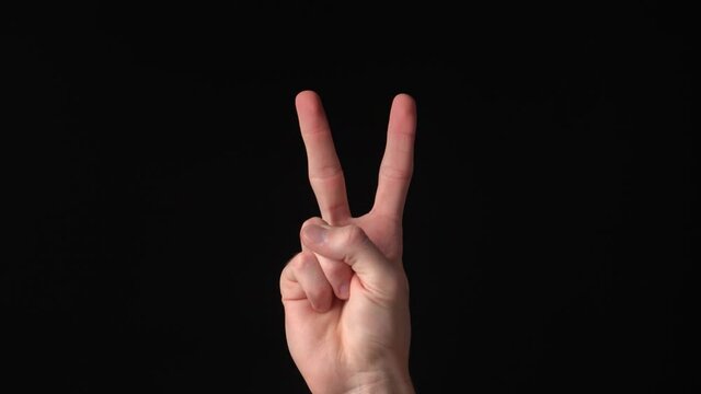 Man's hand showing number one 1, two 2, three 3, four 4, five 5 on black
