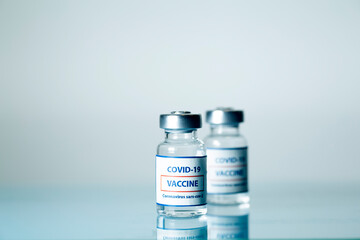 Vaccine against COVID-19. Glass medical vials with liquid. Ampoules with coronavirus vaccine on a...
