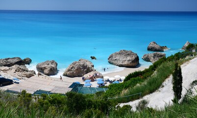 Panoramic view of Megali Petra beach on Lefkada island, Greece. Big boulders on the beach, Adriatic sea, azure sea.