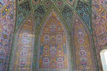 Fototapeta na wymiar Colorful and rosy mosaic patterns on the ceiling of Nasir Al-Mulk Mosque (Pink Mosque) in Shiraz, Iran