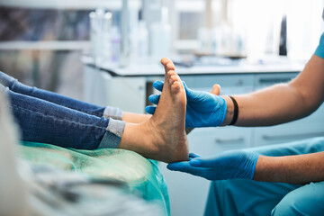 Elegant woman receiving foot treatment in the medical center