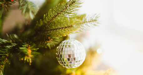 Christmas ball on a Christmas tree with a garland on the background. New Year background