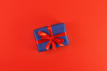 christmas gift on red background. Concept holiday atmosphere, new year, celebration, greeting card. Flatlay, top view, frame, copyspace