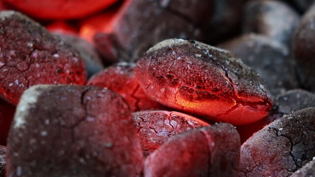 Glowing Charcoal Briquettes, BBQ oder close up of coals burning
