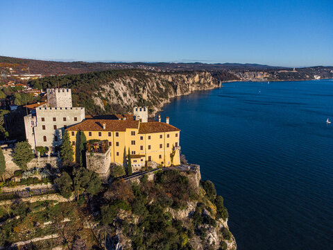 Aerial view of gothic Duino castle on a cliff over the Gulf of Trieste , Italy. 