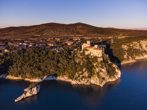 Aerial view of gothic Duino castle on a cliff over the Gulf of Trieste , Italy. 