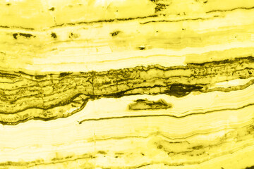 Natural marble texture toned in trendy yellow for background or backdrop. Color 2021 concept. Interior marble stone design.