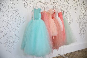 Hanger with colorful elegant puffy dresses for girls. holiday wardrobe. 