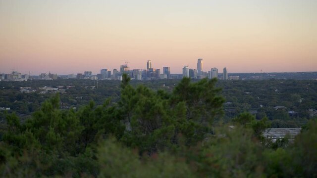Handheld 4k slow motion establishing shot of the cityscape and buildings of Austin, Texas from public park in the warm, south American state