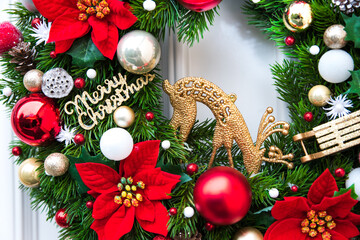 Fototapeta na wymiar Christmas wreath with classic red decoration.