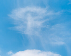 Unusual sky sight, white cloud like a whirlwind in blue sky