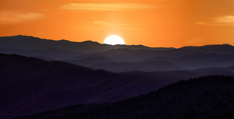 Sunset over the smoky mountains wil rolling hills