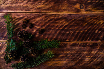 Christmas cones and branches on wooden boards. - 401245549