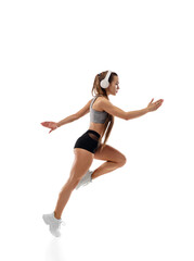Energy. Caucasian professional female athlete, runner training isolated on white studio background. Muscular, sportive woman. Concept of action, motion, youth, healthy lifestyle. Copyspace for ad.