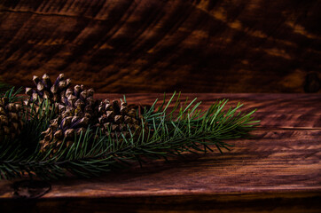 Christmas cones and branches on wooden boards. - 401246334