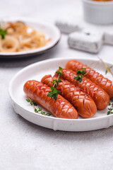 Grilled sausages with roasted onion