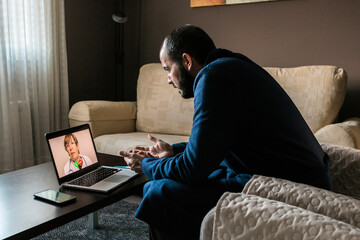 Ill man sitting on sofa during online consultation with doctor. Telehealth, telemedicine, remote consultation service. Coronavirus, COVID-19 - obrazy, fototapety, plakaty