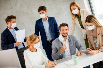 Group of business people have a meeting and working in office and wear masks as protection from coronavirus