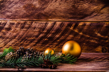 cones and branches on wooden boards with a large Christmas ball. - 401247578