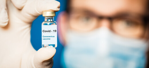 doctor holding covid - 19 coronavirus vaccine