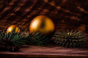 cones and branches on wooden boards with a large Christmas ball. - 401248762