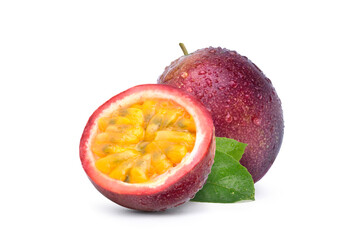 Purple passion fruit (Passiflora edulis) with cut in half and green leaf isolated on white...