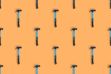 Hammer on an orange background. Hammer seamless pattern.