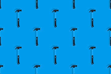 Hammer on a blue background. Hammer seamless pattern.