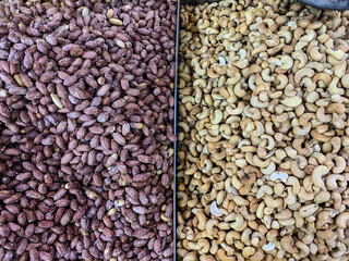 Salted peanuts and white cashews in trays at the market. Netanya, Israel