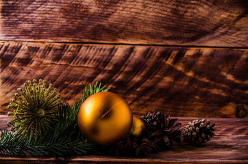 cones and branches on wooden boards with a large Christmas ball. - 401250316