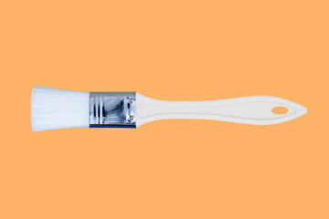 Construction brushes on an orange background. Seamless texture from construction brushes.