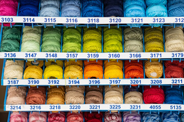 Atelier workshop. A set of colored threads for sewing on reels. A bunch of large multicolored spools of thread.