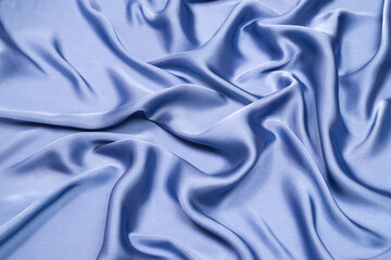 Fototapeta premium Blue silk or satin luxury fabric texture. Top view.