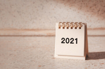 2021 calendar with copy space on left side. Warm tone image, selective focus. Concept of hoping to see a better year, new year resolution.