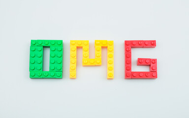 Toy letters O M G for OH My God, On a white background with an empty space for the text,  copy...