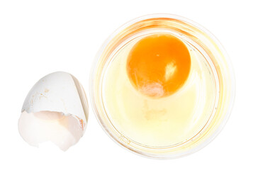 top view of broken chicken egg in glass bowl and empty white shell isolated on white background