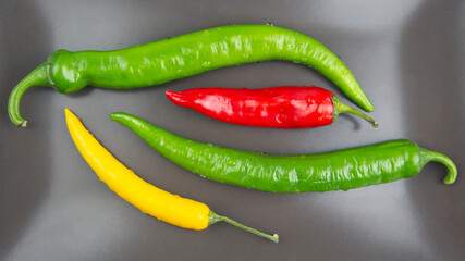yellow, red and green hot chili on a plate. Pepper. Vegetable vitamin food.