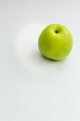 Green apple with white background and space for text