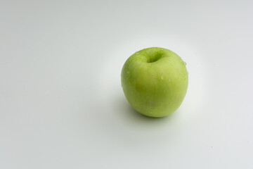 Green apple with white background and space for text