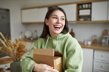 Shipment, delivery, moving and online shopping concept. Happy overjoyed young brunette woman posing...