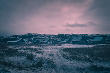 Fototapeta na wymiar Night mystical view of the old Arctic village with abandoned houses