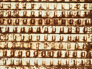 rusting old rack slat wall hanging system left out in the rain to rust