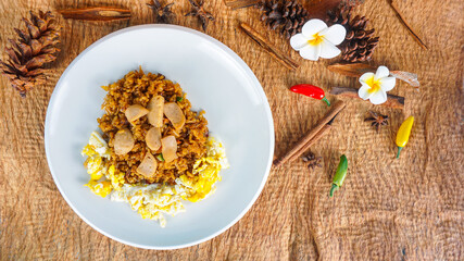 Obraz na płótnie Canvas Fried Rice on wood table. Fried rice nasi goreng with chicken and fried meatballs on a plate