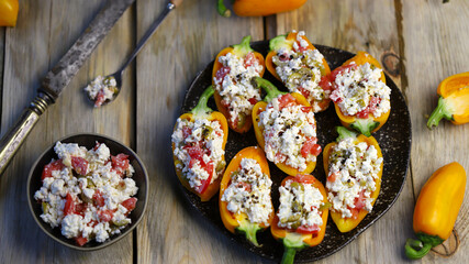 Sweet paprika peppers stuffed with white cheese. Healthy snack. Diet food. Vegetarian meals.