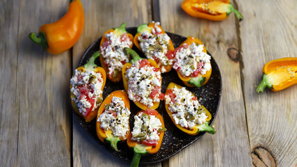 Sweet paprika peppers stuffed with white cheese. Healthy snack. Diet food. Vegetarian meals.