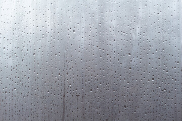 Water droplets on misted glass. Abstract background
